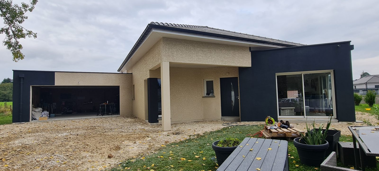 Maison contemporaine de plain-pied, enduit beige et volumes anthracite